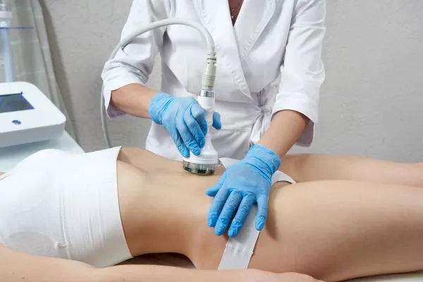 Lost the Weight but Not the Loose Skin? 2 woman having HIFU treatment on her stomach to combat loose skin Sleaford following weight loss